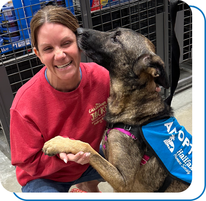 A woman getting a doggy kiss