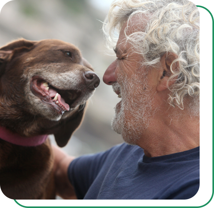 A man laughing with his dog